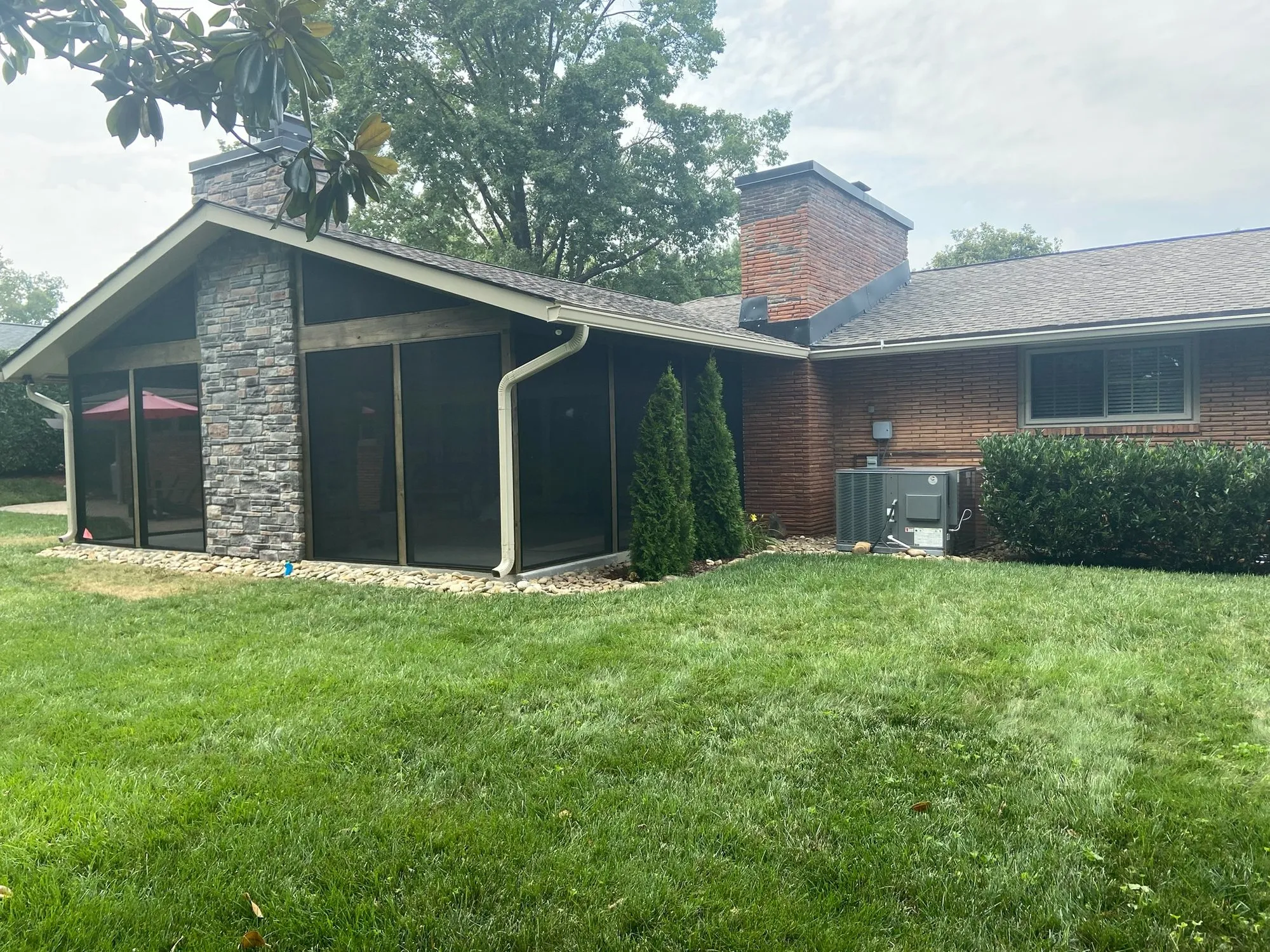 Screen porch with stone chimney